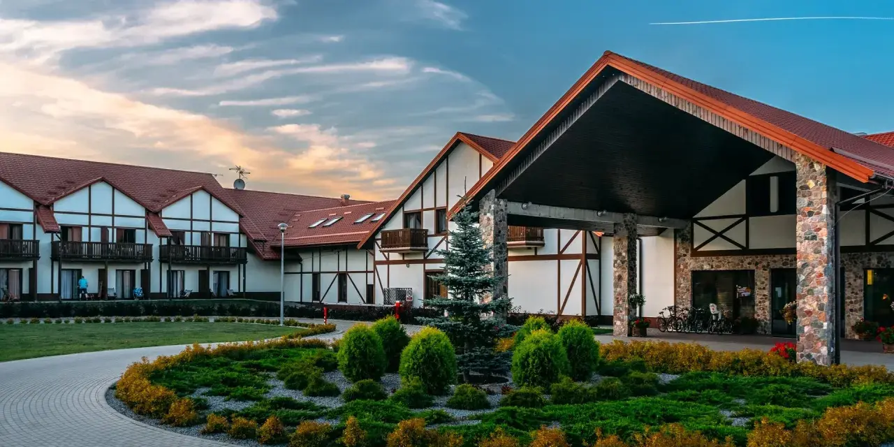 Malowniczy mikołajki resort spa z charakterystyczną architekturą i zadbanym ogrodem.